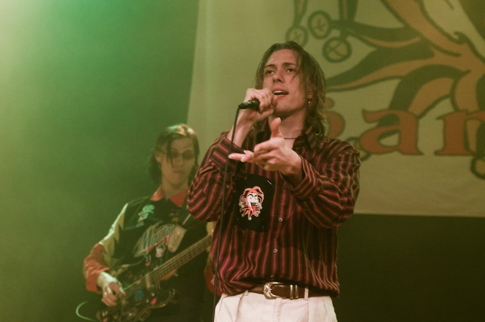 The Garden performing on stage under hazy green lighting