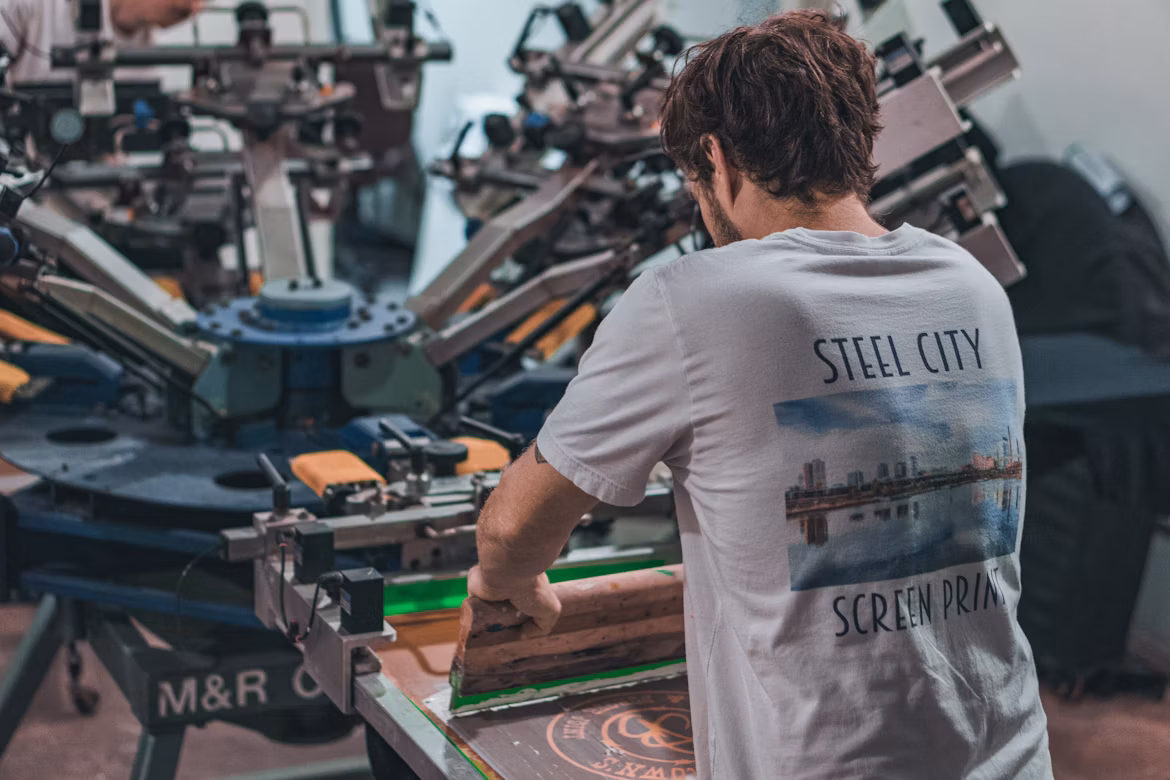 A screen printer working on a graphic T-shirt