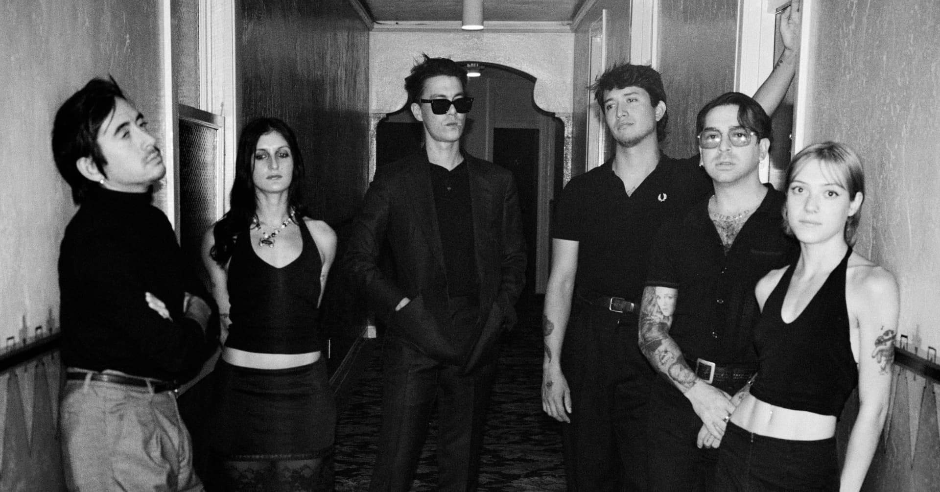 The Buttertones standing together in a black and white hallway portrait