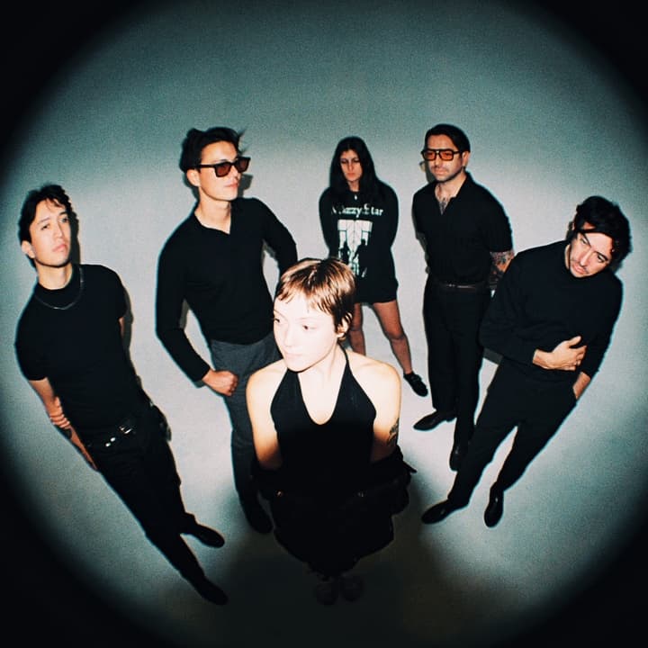 The Buttertones posing together under a fisheye lens